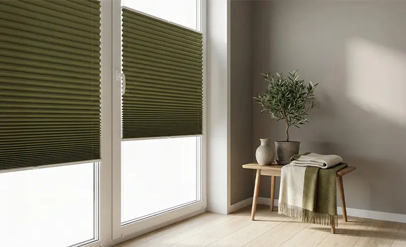 Green pleated blinds fitted to glazed balcony doors.