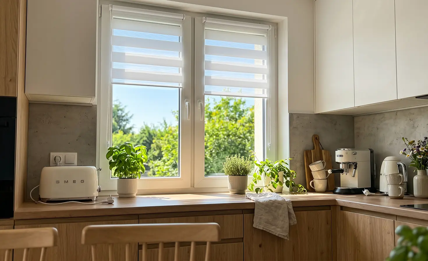Bright kitchen with white day-night roller blinds on the window