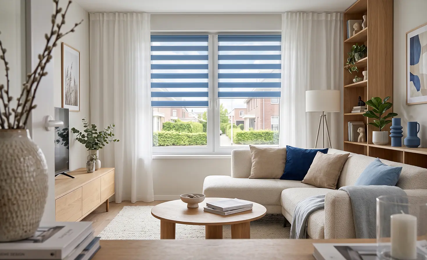A cosy blue-and-white living room. A blue day-and-night blind can be seen in the background.